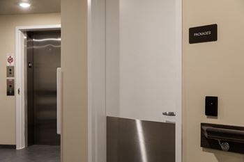 A sign on the wall says "packages" above a door.
